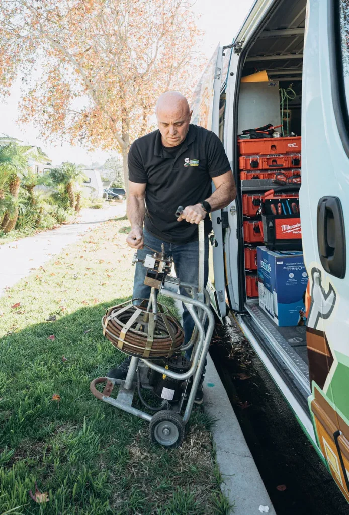 Plumber with drain cabling equipment