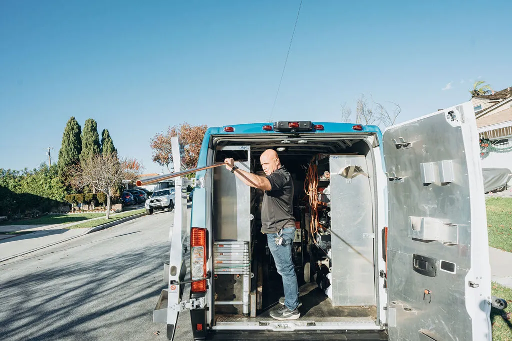 Hydro jetting 2 Wiseway plumber technician getting tools for hydro jetting service from truck