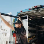 Wiseway technician handling black pipe out of service truck