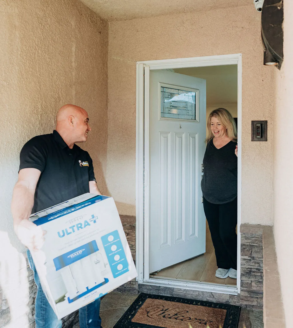 Wiseway worker talking to local neighbor explaining their water softner installation process