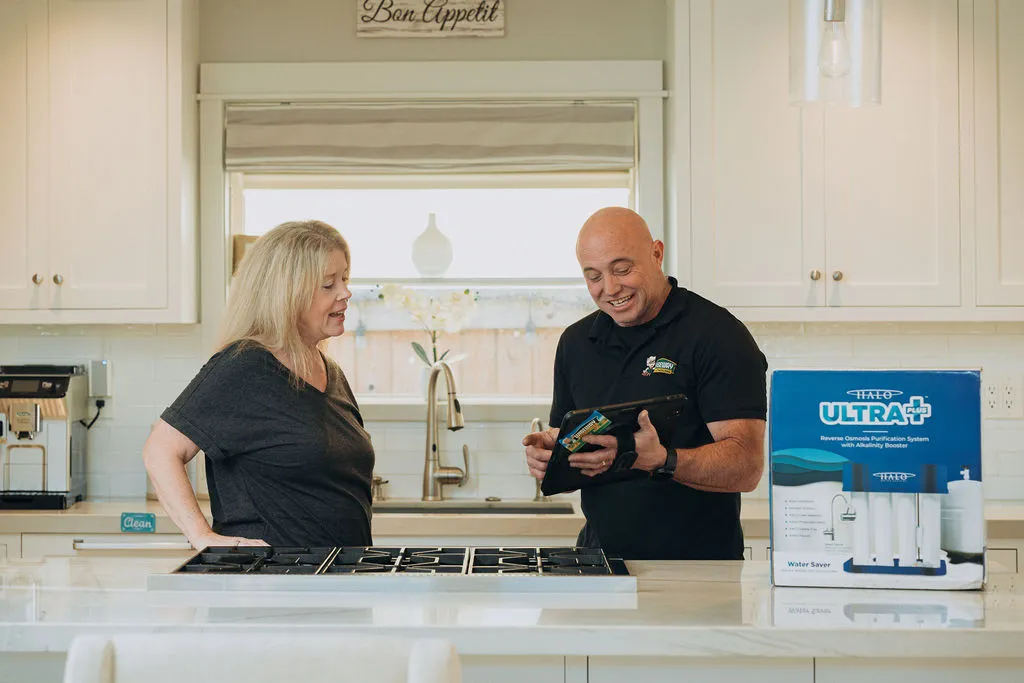 Friendly wiseway plumber with local home customer explaining plumbing services they provide