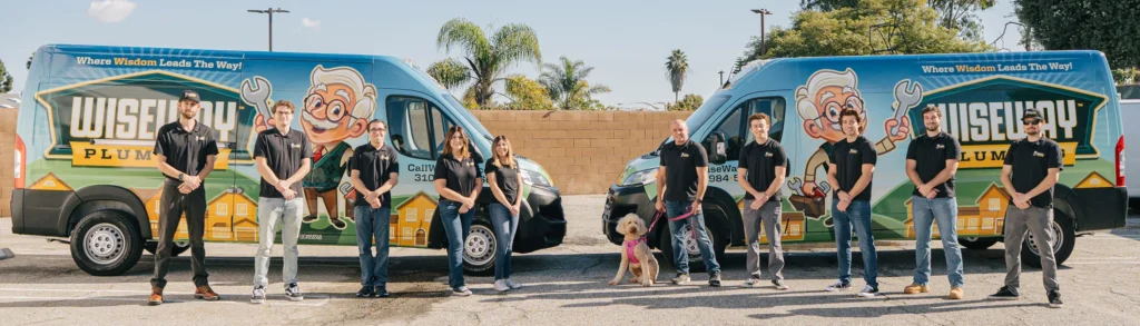 Group photo, wide stance with branded trucks outside